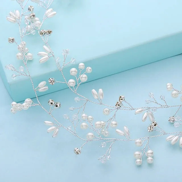 Bridal long hair band with crystals and pearls on a silver wire, shown coiled.