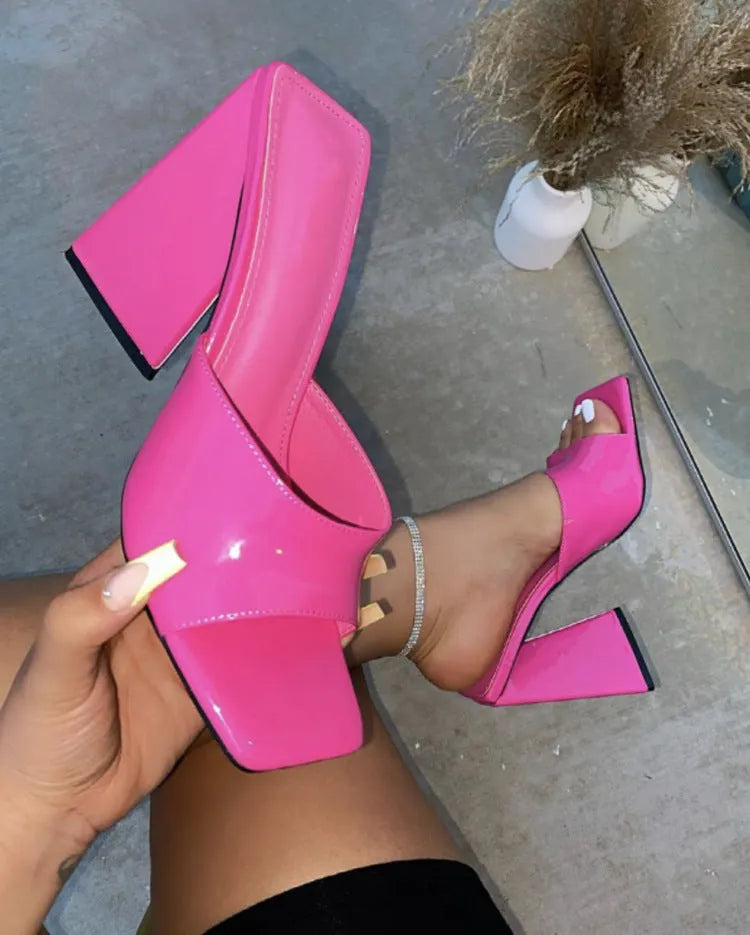 Black women's high heel slippers with square toe and thick triangular rubber sole.
