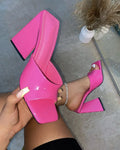 Black women's high heel slippers with square toe and thick triangular rubber sole.