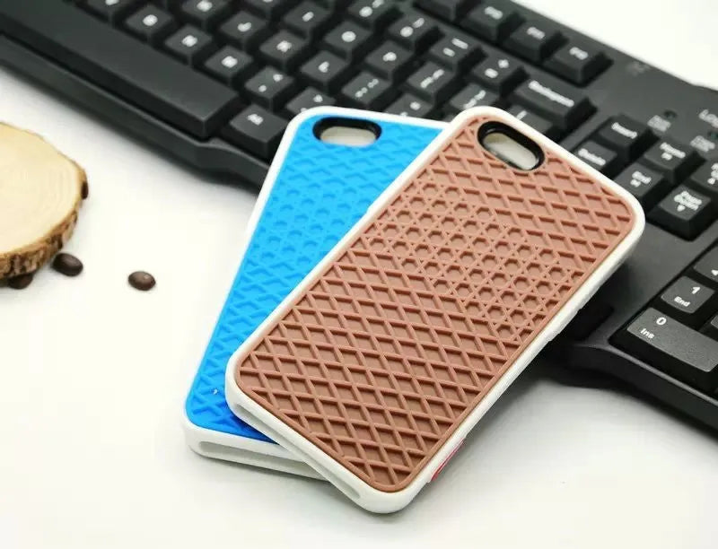 Waffle sole silicone phone case for iPhone 6s with checker pattern texture in black edge on brown background