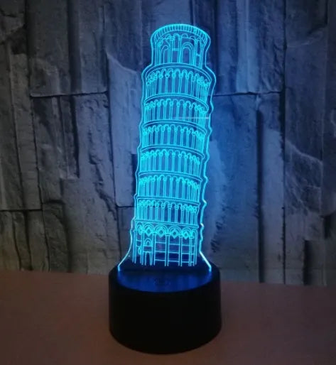 3D laser-cut Leaning Tower of Pisa acrylic night light glowing in blue on a black base.