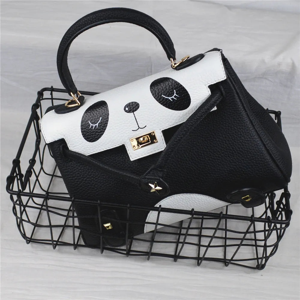 Black and white panda print square leather handbag with horizontal silhouette and structured cowhide body.