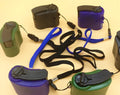 USB hand dynamo charger in green and blue showing winding handle and LED indicator