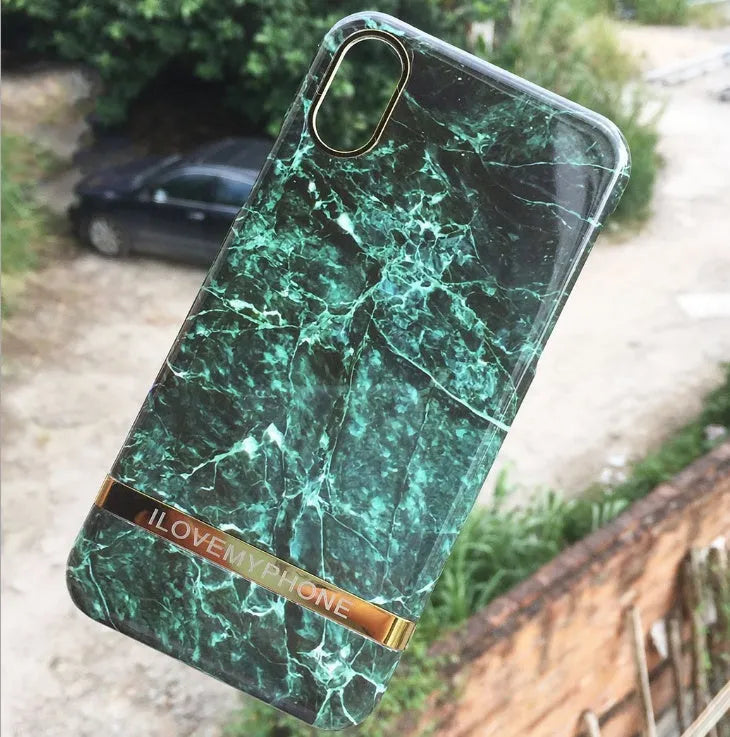 Marble pattern plastic protective case for iPhone in multiple colour options on a dark surface.
