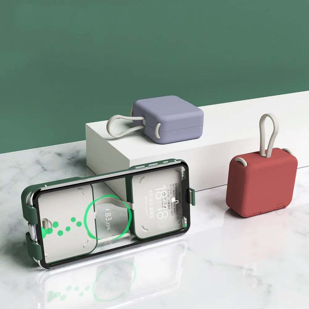 Handbag clip-on portable power bank in blue, shown charging a phone and functioning as a stand.