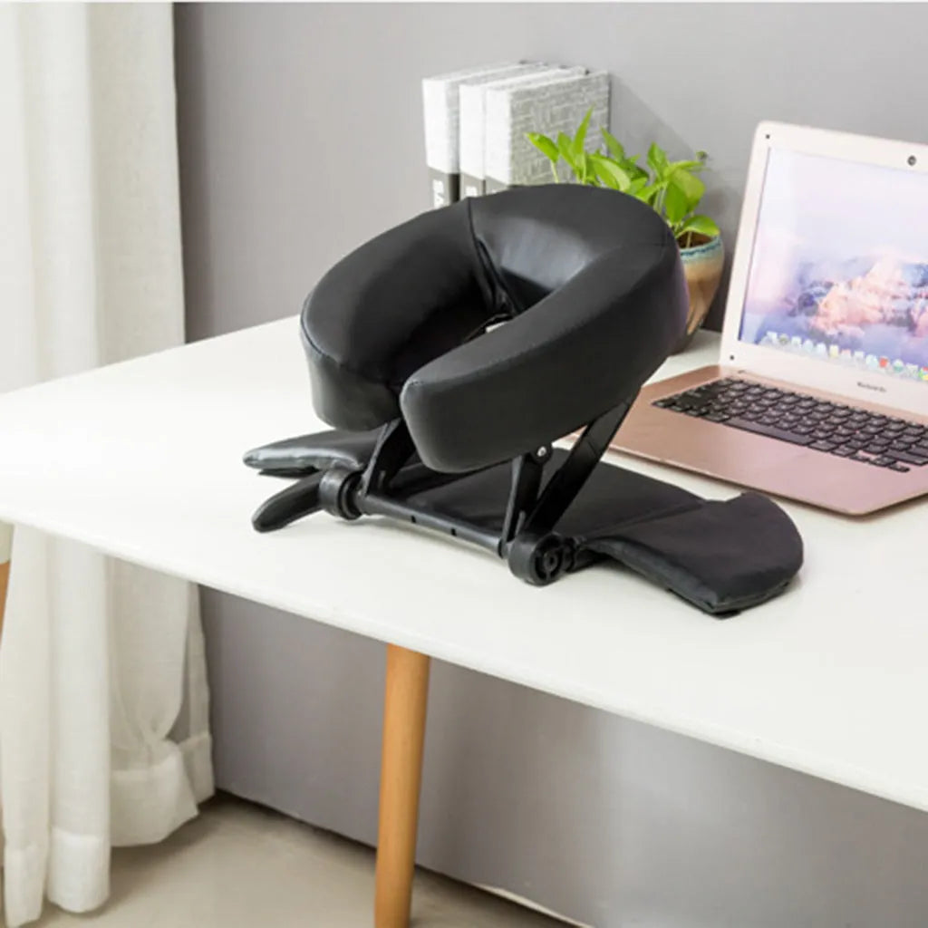 SPA Health U-shaped face pillow with PU leather cover, adjustable height, in black on massage table