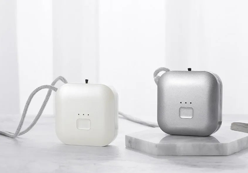 Mini USB portable air purifier necklace in blue, shown worn and with USB cable.