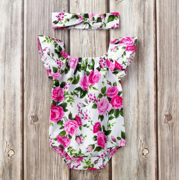 White baby girl's sleeveless cotton romper with small flying sleeves on a hanger.