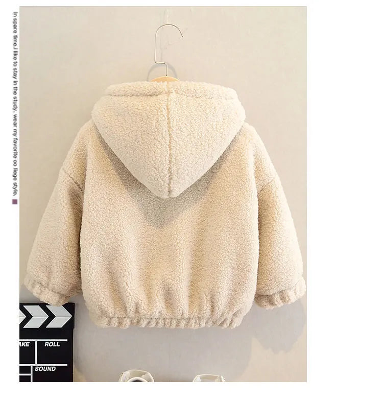 Child wearing a beige cashmere fleece hooded jacket with a cartoon pattern on the front.