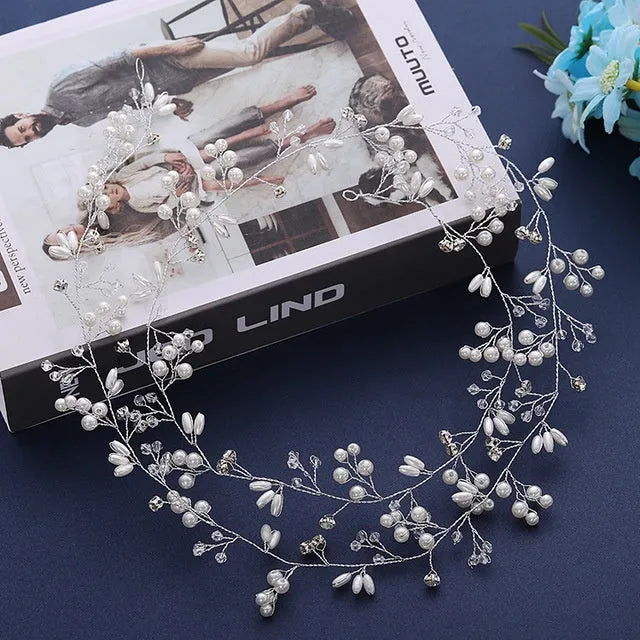 Bridal long hair band with crystals and pearls on a silver wire, shown coiled.