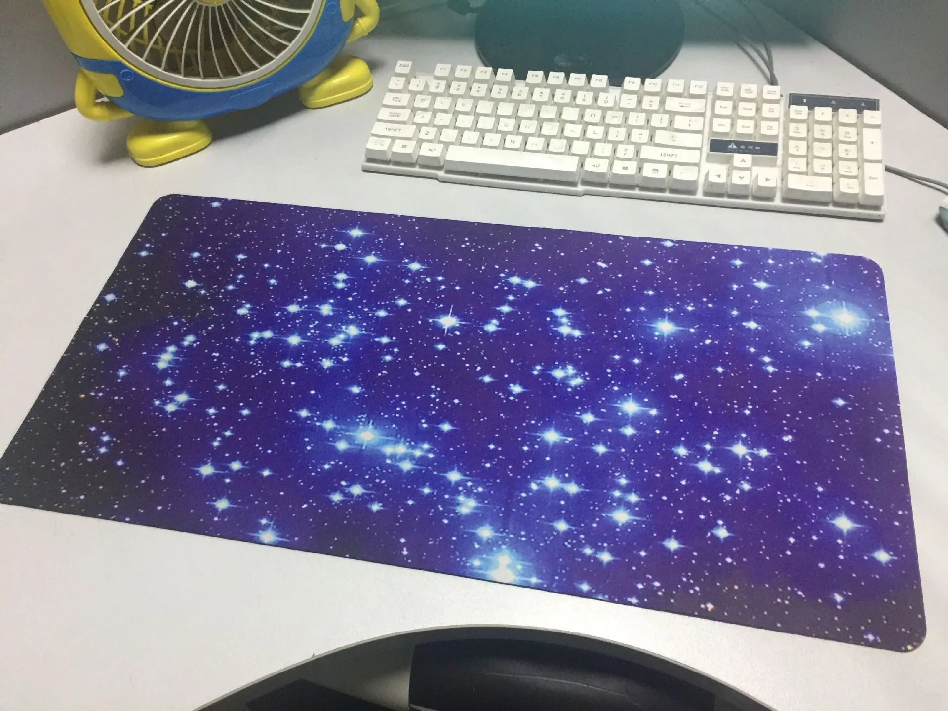 Blue star mouse pad with high-density fabric surface and anti-skid rubber base on a desk
