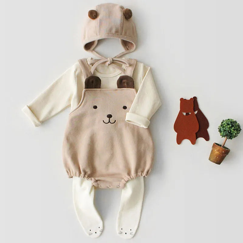 Baby sleeveless strapless cotton robe with detachable hood in brown or white on a plain background