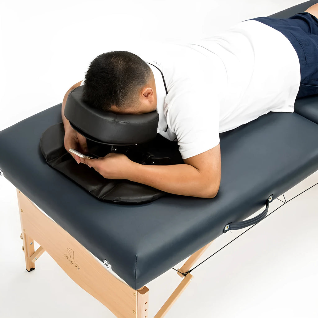 SPA Health U-shaped face pillow with PU leather cover, adjustable height, in black on massage table
