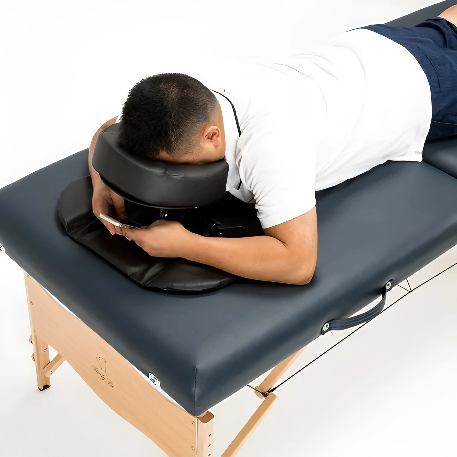 SPA Health U-shaped face pillow with PU leather cover, adjustable height, in black on massage table