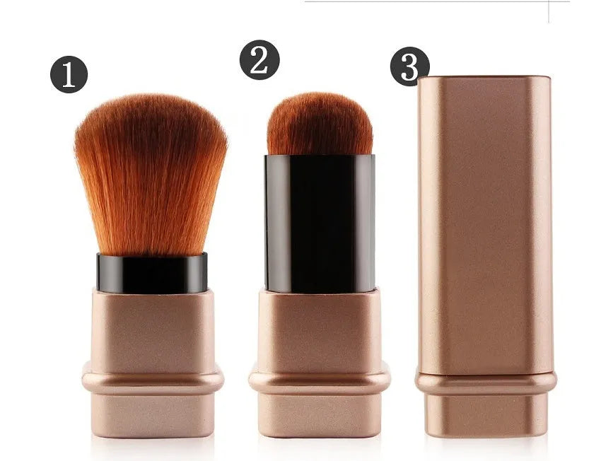 Portable single makeup brush with man-made fibre bristles and square gold plastic handle on white background