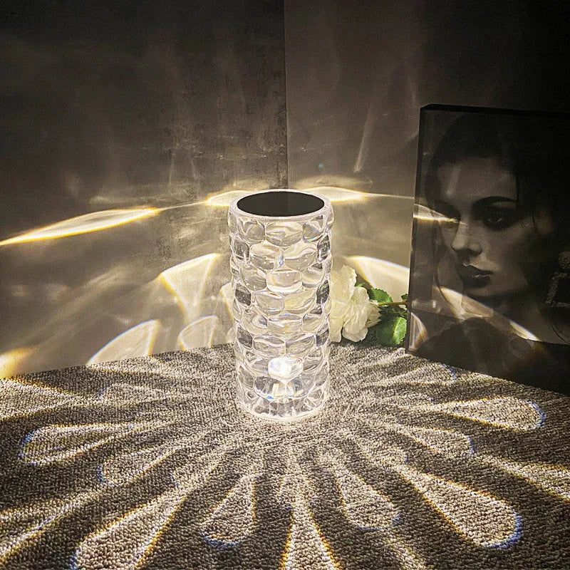 Crystal table lamp rechargeable with teardrop acrylic shade showing droplet shadow effect on a bedside table