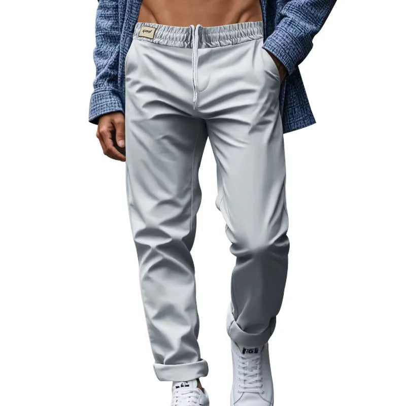 Men's casual trousers in solid grey, loose fit with drawstring waist and side pockets, full length