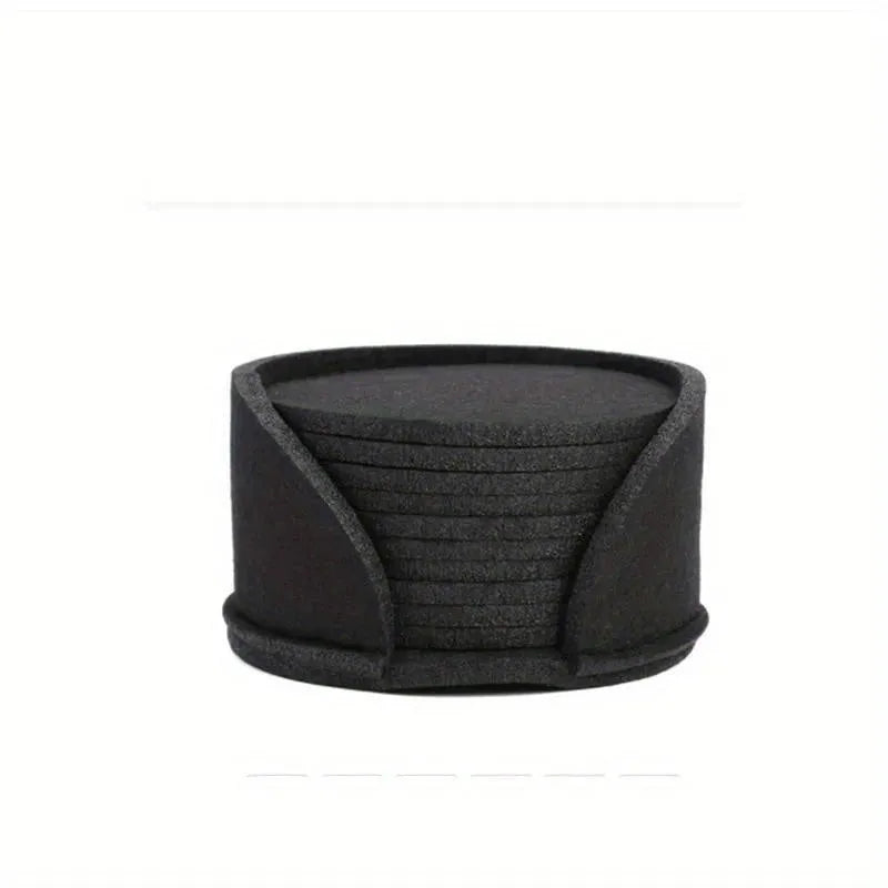 10 round felt coasters in black, brown, dark gray, and light gray arranged on a dining table