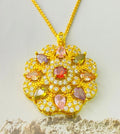 Close-up of a women's floral-shaped zircon pendant necklace in a gold colour finish with a matching chain.