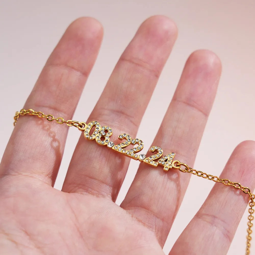 Stainless steel digital bracelet with diamond-studded numbers in gold finish