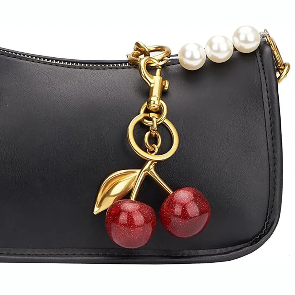 Red zinc alloy 3D cherry keychain pendant with metal loop for keyring attachment.
