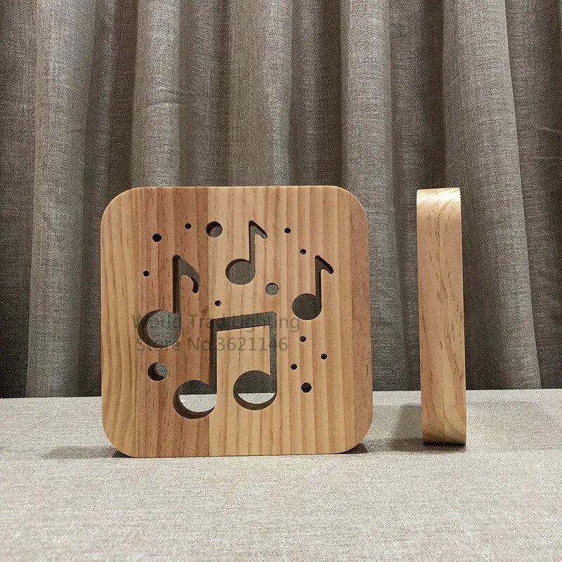 Square pine wood USB LED lamp with warm white light on a wooden desk next to a laptop.