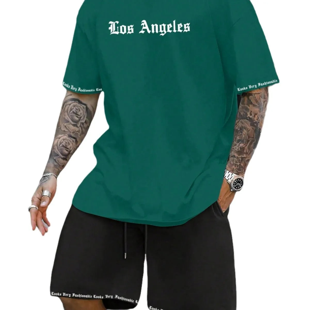 Man wearing a grey short-sleeved sports top and matching shorts from a quick-dry two-piece set.