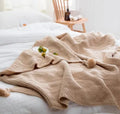 Nordic style fringed knit ball blanket in acrylic fabric, size 130x170cm, shown in beige colour