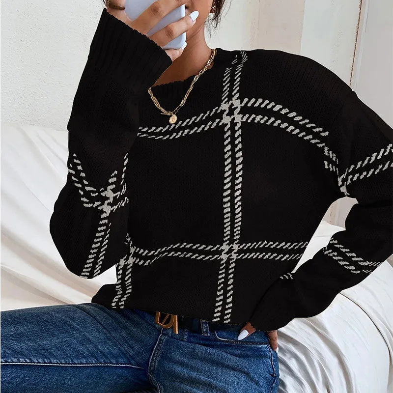 Women's apricot, black, beige, red and green plaid colour-block crew neck acrylic sweater on a hanger