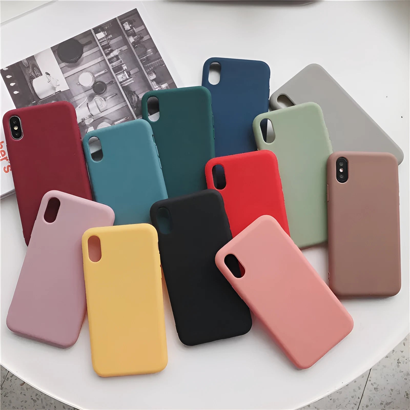 Silicone phone case for iPhone shown in wine red, light blue, grey, dark green, begonia, rose gold, bean green, and black colours.