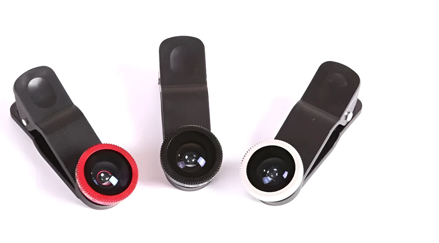 Mini camera lens clip for mobile phone in black attached to smartphone showing clip-on design
