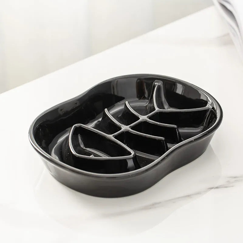 Ceramic shallow cat bowl in black on a light background, showing wide lip and low profile for whisker comfort