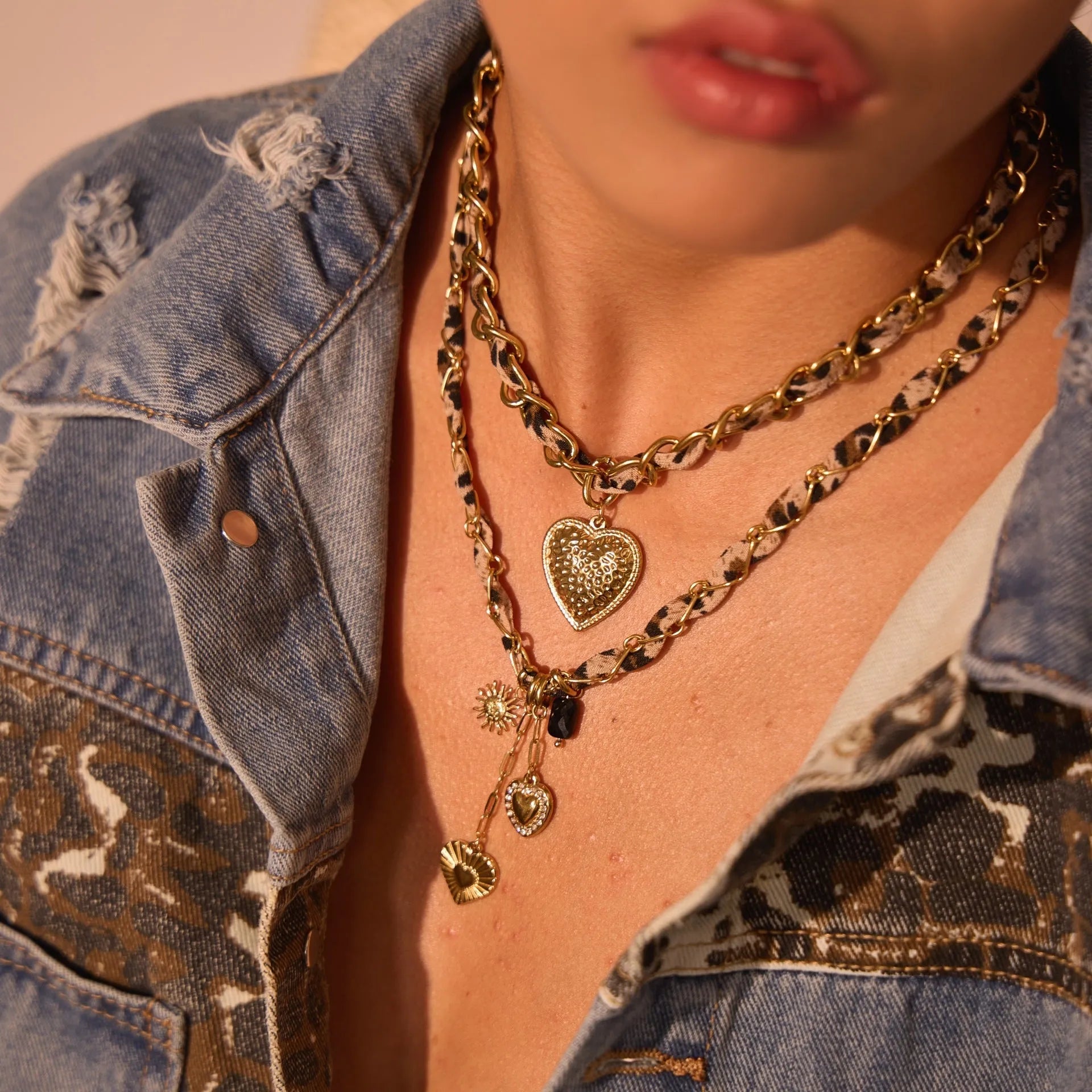Geometric leopard love pendant necklace on a stainless steel chain with 18K gold electroplate.