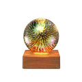USB plug-in crystal ball night light displaying colourful firework pattern on a dark surface.