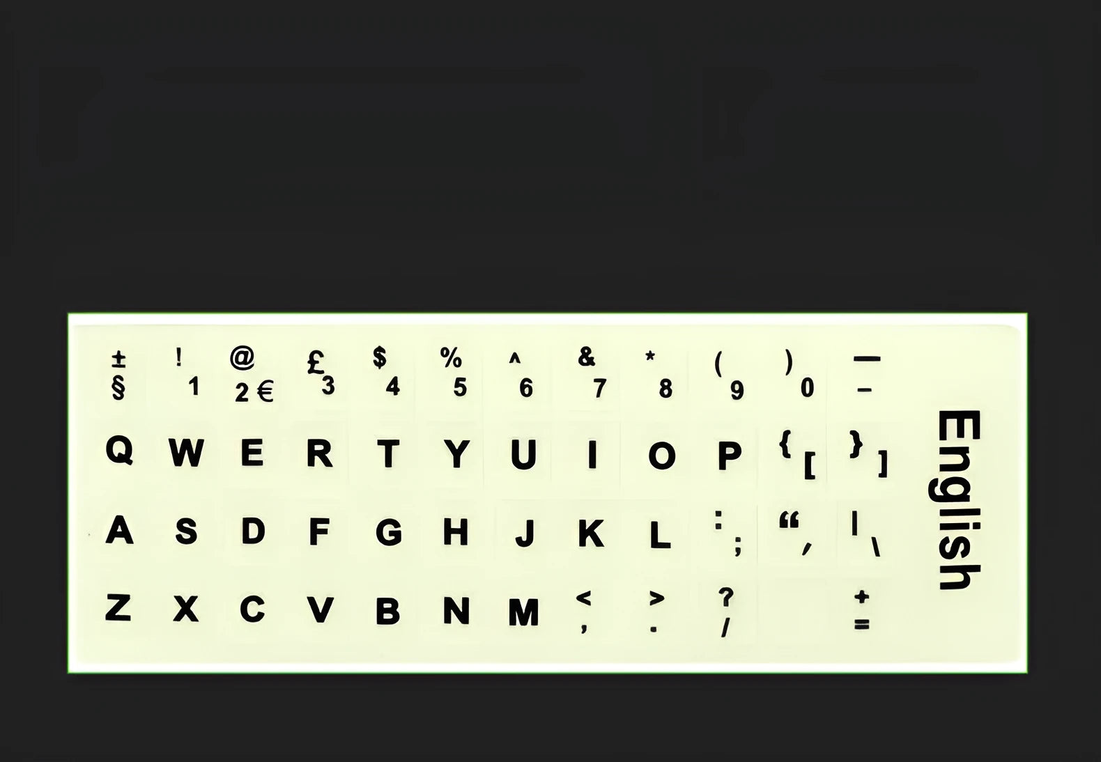 Glowing yellow multilingual keyboard stickers showing Arabic, Thai, Hebrew, French, Italian and German characters