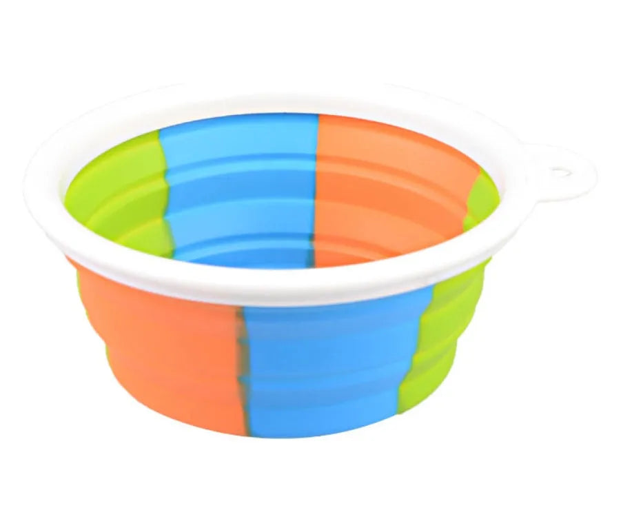Collapsible silicone dog bowl in camouflage pattern folded flat on green surface