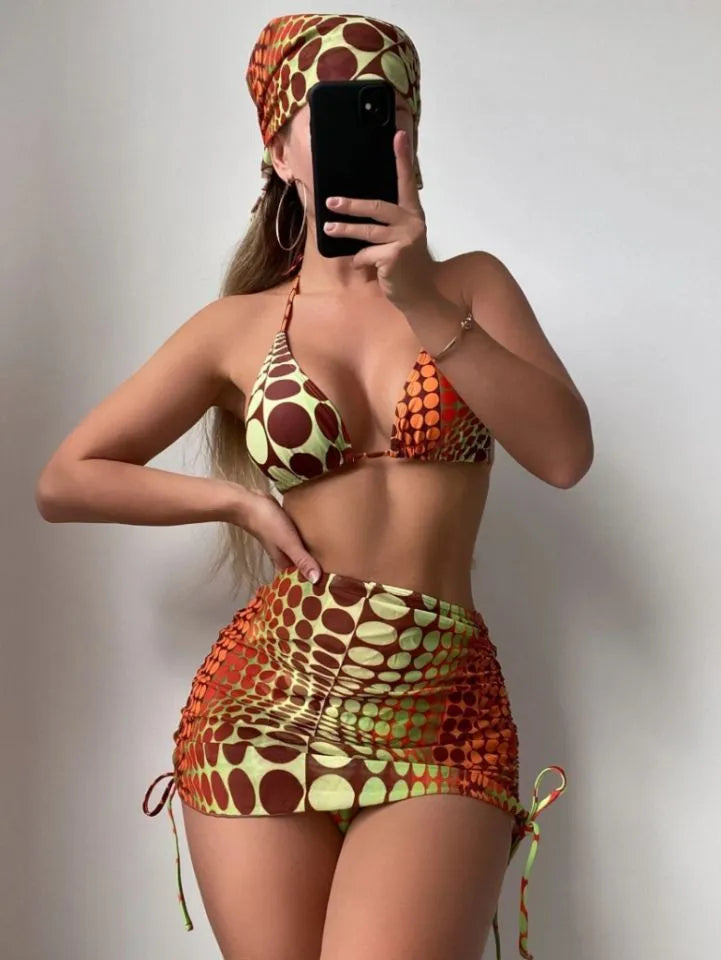 Printed split bikini set with chest pad, shorts, skirt, and headband in polyester on woman