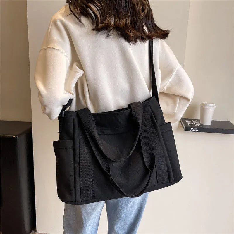 Large solid colour polyester shoulder tote bag with external pocket and internal phone compartment