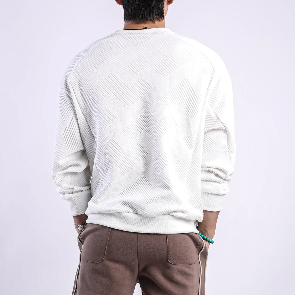 Man wearing a loose-fitting army green twill jacquard long-sleeved pullover sweater.