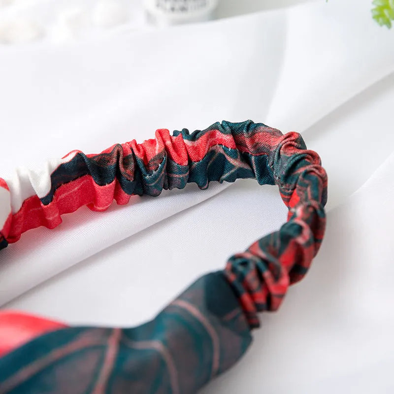 Red cloth headband with embroidered banana leaf cross pattern for women's festival wear