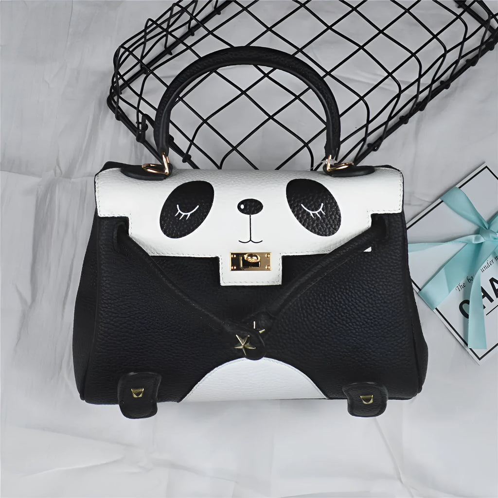 Black and white panda print square leather handbag with horizontal silhouette and structured cowhide body.