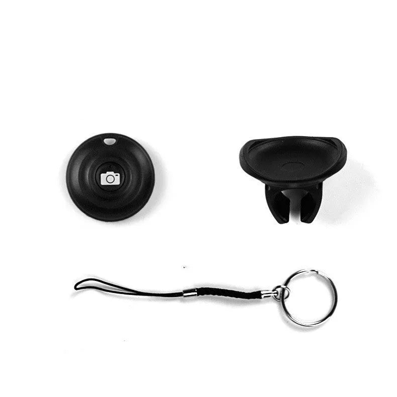 Black Snap Bluetooth remote control for smartphone photos on a white background.