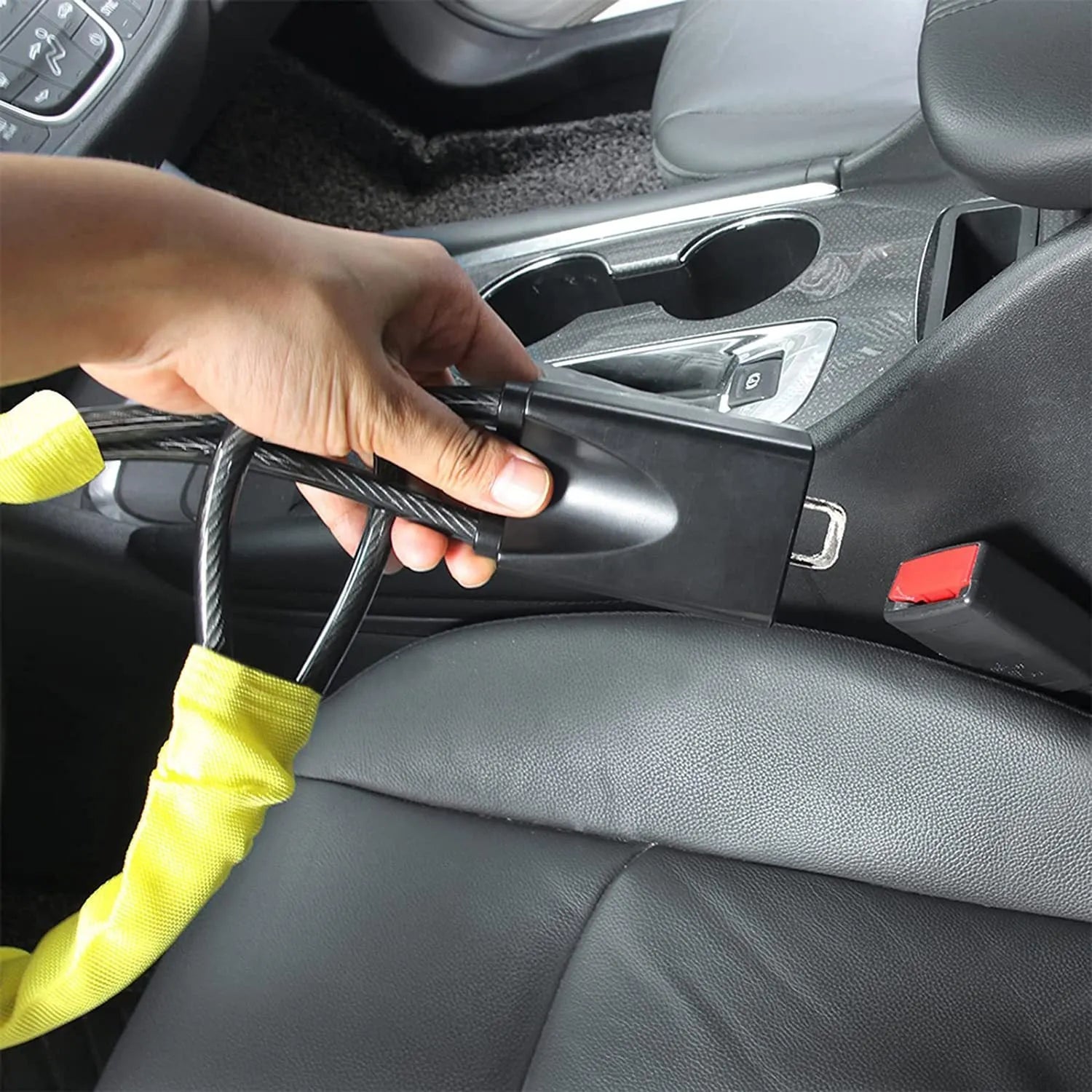 Red iron car steering wheel lock with copper core for General Motors vehicles on a steering wheel.