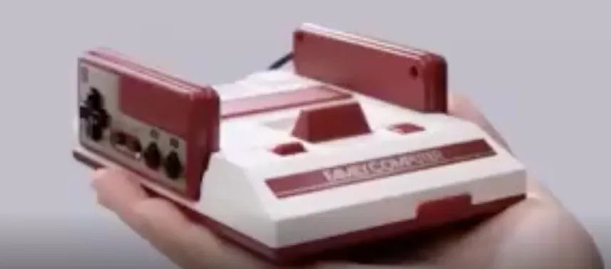 Mini FC game console in red and white with wired controllers and AV cable for TV play