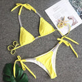 Strapless solid colour bikini in black, orange, white, or yellow, nylon outer and polyester lining, sizes S M L