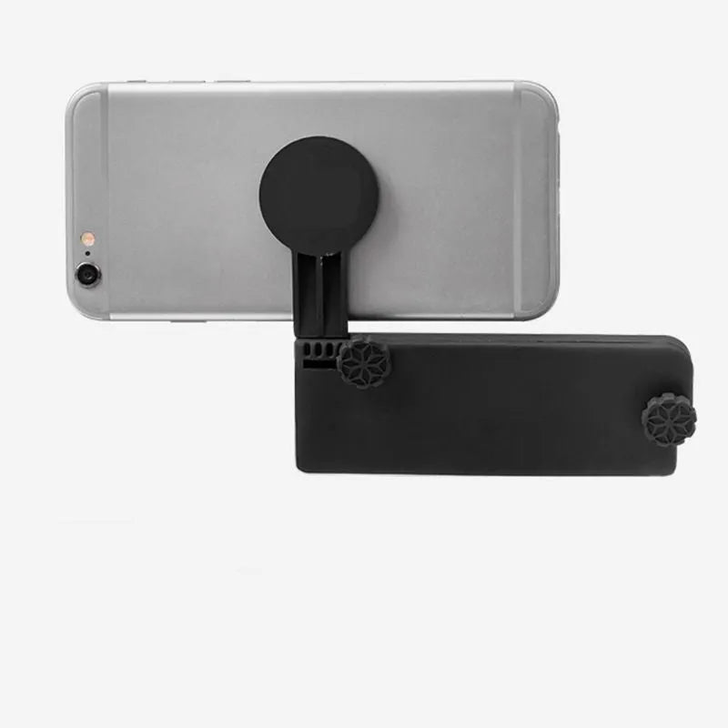 Black silicone computer side screen clip phone holder attached to a laptop, with a smartphone held magnetically