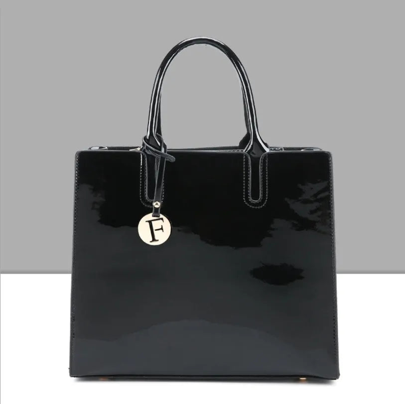 Three soft patent leather handbags in solid colours for women, shoulder and crossbody style with zipper closure
