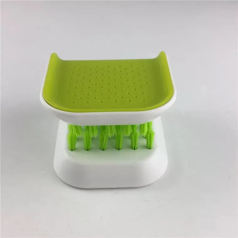 Blue U-shaped plastic brush for cleaning knives and forks in kitchen sink