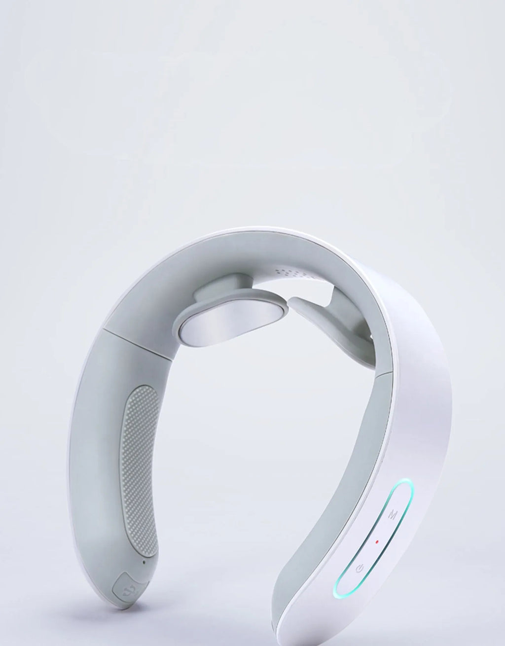 White electric acupressure massager with control buttons on a grey background.