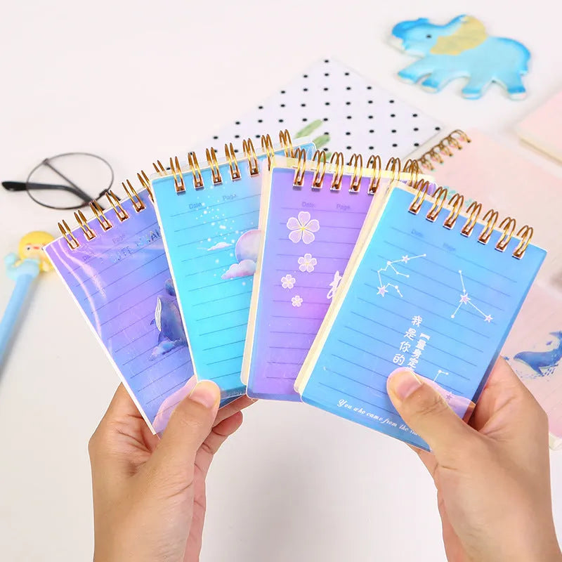 Pack of four A7 spiral-bound notebooks with decorative PP covers in various colours.